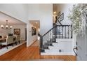 Bright foyer with hardwood floors, staircase, and views into dining room and hallway at 640 Saddle Ridge Trce, Roswell, GA 30076