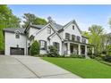 Stunning two-story home with painted brick, a side-entry garage, and lush landscaping at 369 Pinecrest Ne Rd, Atlanta, GA 30342