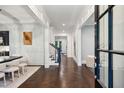 Grand foyer showcasing herringbone wood floors, white trim, and staircase in view at 369 Pinecrest Ne Rd, Atlanta, GA 30342