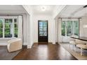 Bright foyer with herringbone floors, large windows, and stylish decor at 369 Pinecrest Ne Rd, Atlanta, GA 30342