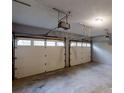Spacious two-car garage with ample lighting and concrete floors, ready for parking and storage at 3979 Sharon Spgs, Powder Springs, GA 30127