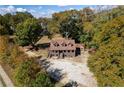 A charming home sits on a spacious lot, surrounded by mature trees and lush landscaping at 5098 Meadows Rd, Powder Springs, GA 30127