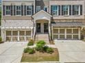 Charming townhome showcasing a welcoming entrance and beautifully landscaped front yard at 815 Paden St, Woodstock, GA 30188