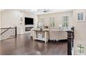 Bright living room featuring a stone fireplace, hardwood floors, and modern ceiling fan at 815 Paden St, Woodstock, GA 30188