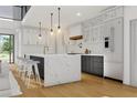Gourmet kitchen with an island, quartz countertops, modern lighting, and stainless steel appliances at 1484 N Druid Hills Ne Rd, Brookhaven, GA 30319