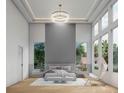 Bright main bedroom featuring modern tray ceiling with chandelier and large windows at 1484 N Druid Hills Ne Rd, Brookhaven, GA 30319