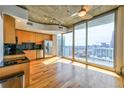 Modern kitchen featuring stainless steel appliances, wood cabinets, and an adjacent outdoor view at 860 Peachtree Ne St # 2716, Atlanta, GA 30308