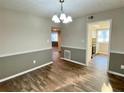 Dining room with hardwood floors, two-tone paint, and chandelier lighting at 927 Pine Oak Trl, Austell, GA 30168