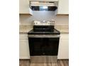 Stainless steel GE range with flat top and stainless vent hood at 927 Pine Oak Trl, Austell, GA 30168