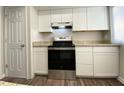 Kitchen with updated white cabinets, granite countertops, and stainless steel appliances at 927 Pine Oak Trl, Austell, GA 30168