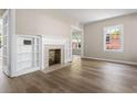 Sun-filled living room with hardwood floors, fireplace, and built-in shelving at 1700 John Calvin Ave, Atlanta, GA 30337