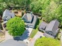 Aerial view of home with a large driveway and surrounded by mature trees at 210 Cole Ct, Canton, GA 30114