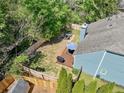 Aerial view of a fenced backyard with deck, fire pit, lawn, and privacy landscaping at 210 Cole Ct, Canton, GA 30114