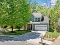 Charming blue two-story home with a large front yard and driveway at 210 Cole Ct, Canton, GA 30114