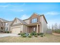 Two-story home with beige siding and a brick front, set against a blue sky at 4354 Favored Way, Union City, GA 30291