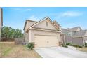 A two-story house featuring beige siding and a two-car garage on a sunny day at 4354 Favored Way, Union City, GA 30291
