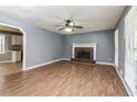 Cozy living room showcasing a brick fireplace and hardwood floors at 495 Stratford Dr, Douglasville, GA 30134