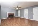 Inviting living room featuring a brick fireplace and hardwood floors at 495 Stratford Dr, Douglasville, GA 30134