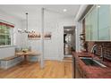 Bright kitchen nook with a built-in banquette, hardwood floors, and brick wall accent at 65 Peachtree Memorial Nw Dr # 5, Atlanta, GA 30309