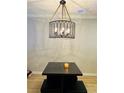 Dining room with hanging light fixture over wooden table at 115 Winding River Dr # B, Atlanta, GA 30350