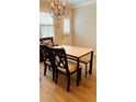 Bright dining area featuring light wood floors and a modern table set at 115 Winding River Dr # B, Atlanta, GA 30350