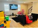 Cozy living room featuring neutral tones, a black sofa, and a large window at 115 Winding River Dr # B, Atlanta, GA 30350