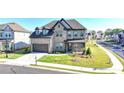 Attractive two-story brick home featuring a two-car garage, a covered front porch, and a well-maintained lawn at 4409 Encore Park Lane, Duluth, GA 30097