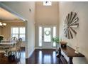 Elegant foyer with hardwood floors, high ceilings, and beautiful decor leading to the dining room at 453 Thorn Creek Way, Dallas, GA 30157