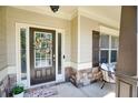 Charming front porch featuring a decorative wreath and stone accents by the front door at 453 Thorn Creek Way, Dallas, GA 30157