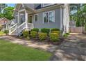 Lovely gray home with lush landscaping, a brick walkway, and a private driveway for easy access at 60 Spence Se Ave, Atlanta, GA 30317