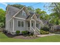 Side angle of a craftsman-style home boasting professional landscaping, gray siding, and inviting front porch at 60 Spence Se Ave, Atlanta, GA 30317