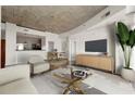 Modern living room featuring hardwood floors, concrete ceilings, and contemporary furniture at 250 Pharr Ne Rd # 905, Atlanta, GA 30305