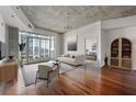Spacious living room with hardwood floors, balcony access, and a view into the bedroom at 250 Pharr Ne Rd # 905, Atlanta, GA 30305