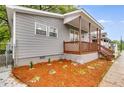 Attractive home with a wood porch, manicured flower beds, and gray siding at 926 Welch Sw St, Atlanta, GA 30310