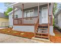 Inviting front porch with wood railings, fresh mulch, and updated gray siding at 926 Welch Sw St, Atlanta, GA 30310