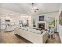 Open concept living room with a brick fireplace, hardwood floors, kitchen and dining areas at 1195 Awenasa Dr, Villa Rica, GA 30180