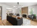 Open-concept living room with a fireplace, stylish furnishings, and seamless access to the dining area at 126 Marona Ne St, Atlanta, GA 30307