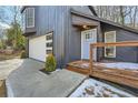 Beautiful covered porch, and stylish garage door, enhance this home's appeal with its inviting entryway and modern accents at 3214 Cedar Bluff Ne Dr, Marietta, GA 30062