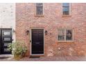 Brick townhouse with a front door and black hardware, complemented by a charming brick driveway at 383 6Th Ne St # 4, Atlanta, GA 30308