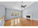 Bright living room with hardwood floors, a fireplace and large windows offering ample natural light at 3898 Hadley Farm Dr, Marietta, GA 30066
