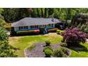 Charming single-story home with a well-maintained lawn, landscaping, and carport at 4519 Sims Ct, Tucker, GA 30084