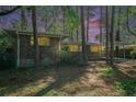 Brick home featuring a carport, situated among trees at dusk at 2480 Warwick Ne Cir, Atlanta, GA 30345