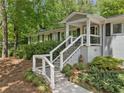 Inviting front entrance with well-manicured landscaping and a charming staircase leading to the front porch at 2574 Warwick Dr, Marietta, GA 30062