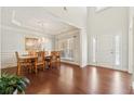 Elegant dining room with hardwood floors, tray ceiling, chandelier, and traditional furniture, perfect for Gathering gatherings at 4650 Brighton View Trl, Cumming, GA 30040
