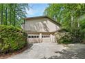 Spacious three-car garage with ample parking and mature landscaping at 4553 Pond Ln, Marietta, GA 30062