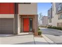 Stylish townhome features a bright red front door, neutral siding, and attached garage at 504 Rankin Ne St # 4, Atlanta, GA 30308