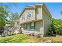 Two-story home with green siding, a green lawn, and multiple trees surrounding the house at 126 Amberwood Ln, Euharlee, GA 30145