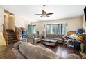 Cozy living room with sofas, wood flooring, and a ceiling fan at 126 Amberwood Ln, Euharlee, GA 30145