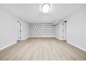Finished basement with stylish accent wall and durable floors, ready for flexible use and entertainment at 3 S Riversong Ln, Alpharetta, GA 30022