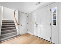 Inviting foyer with tiled stairs, hardwood floors, natural light, and convenient access to upper levels at 3 S Riversong Ln, Alpharetta, GA 30022